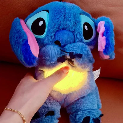 Hand pressing glowing belly of Stitch plush