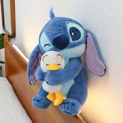 Disney Stitch plush doll with duck on bed