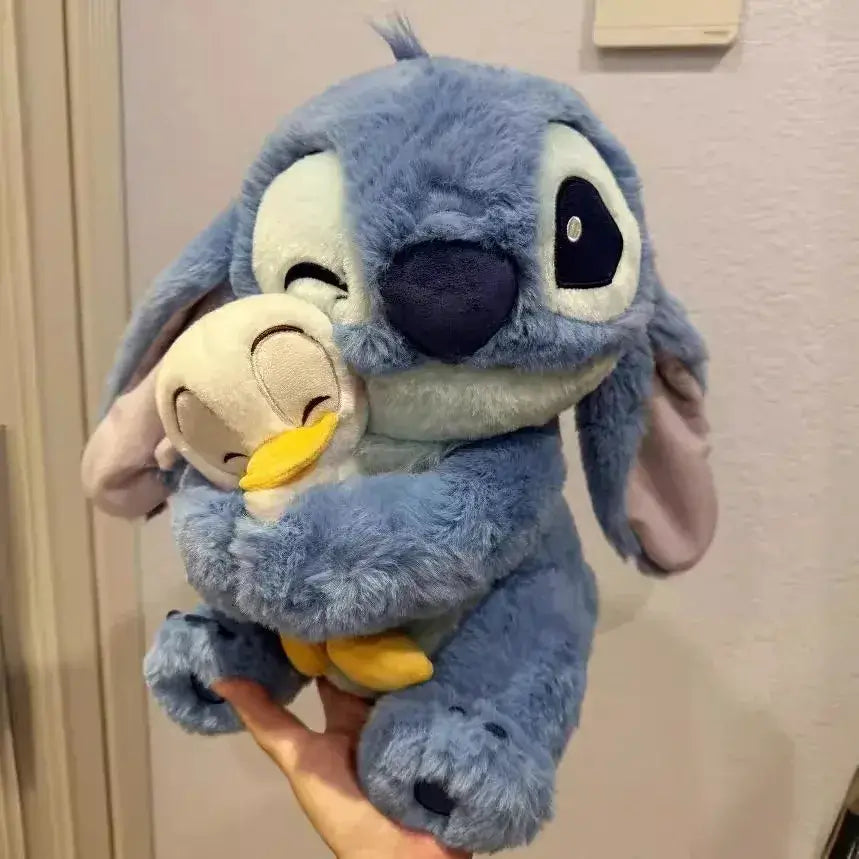 Hand holding Disney Stitch plush doll with duck